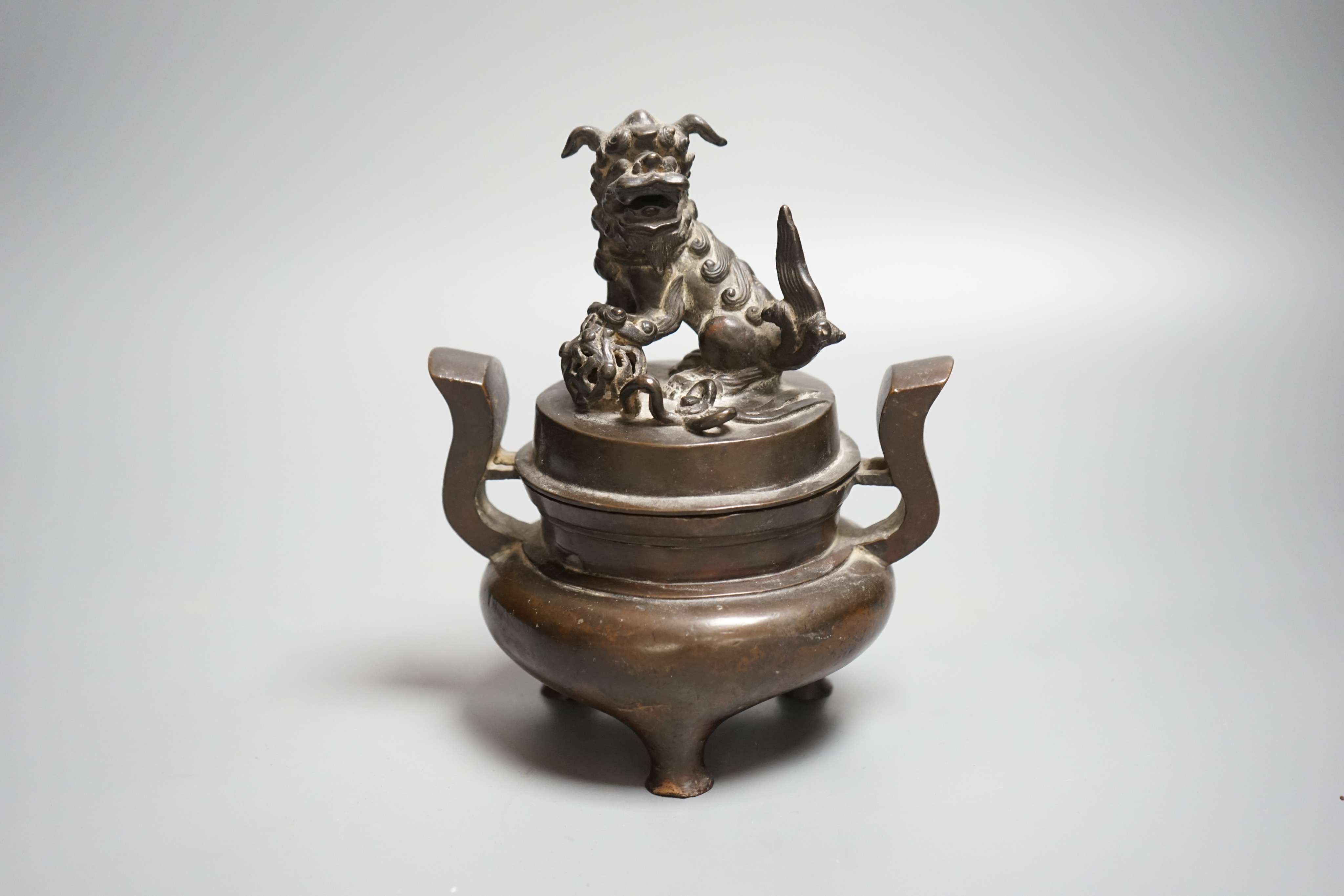 A Chinese copper alloy censer and cover with lion dog cover, height 20cm